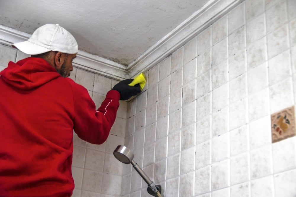 A,Man,In,A,Red,Sweatshirt,And,White,Cap,Cleaning